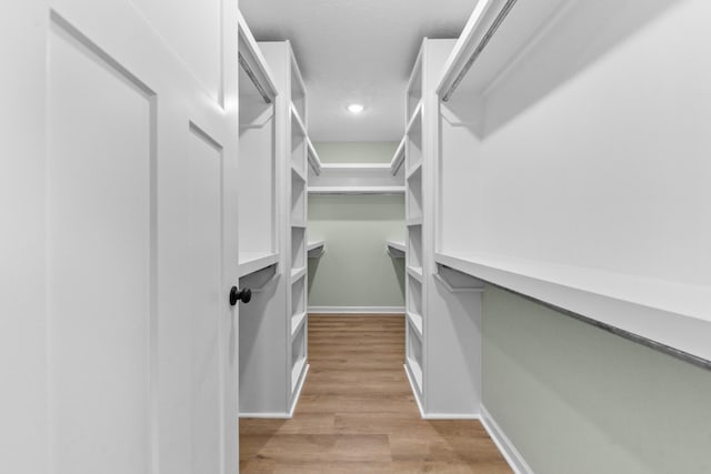 spacious closet with light wood-style floors