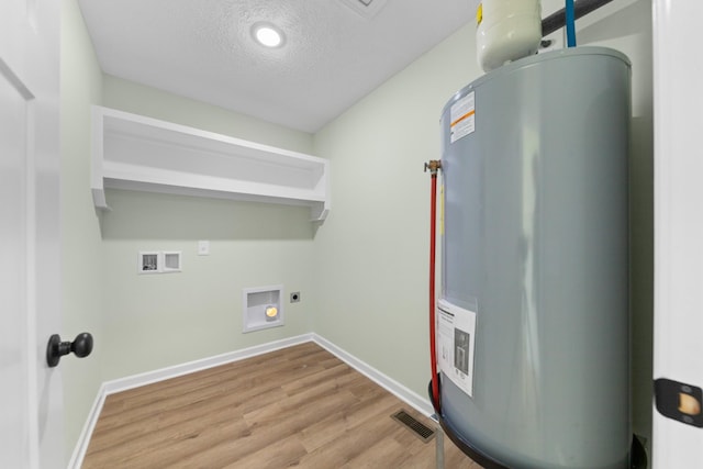 utility room with water heater and visible vents