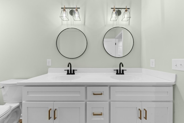 bathroom featuring a sink, toilet, and double vanity