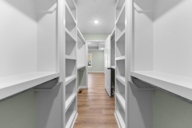 spacious closet featuring light wood-style flooring