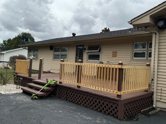 rear view of property with a wooden deck