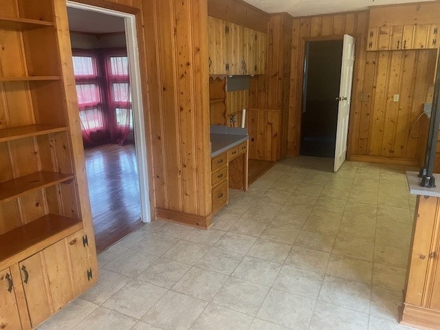 interior space with light hardwood / wood-style flooring and wood walls