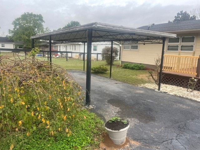 view of vehicle parking with a carport and a yard