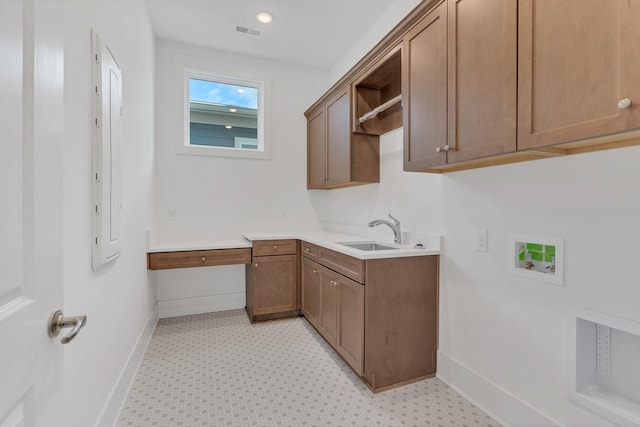 clothes washing area featuring cabinet space, visible vents, baseboards, washer hookup, and a sink