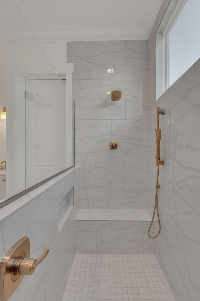 full bath featuring ornamental molding and tiled shower