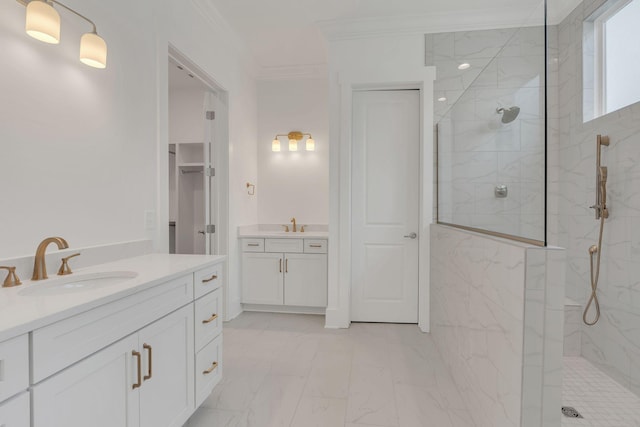 full bathroom featuring two vanities, a sink, marble finish floor, ornamental molding, and a marble finish shower