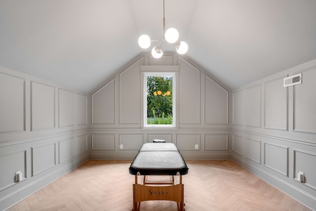 sitting room with a notable chandelier, vaulted ceiling, and light parquet floors