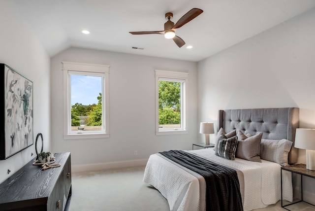 carpeted bedroom with ceiling fan and lofted ceiling