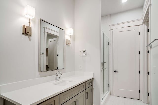 bathroom featuring vanity and an enclosed shower