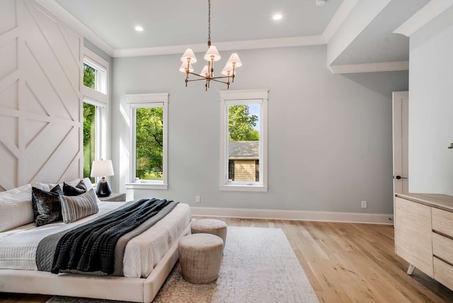 bedroom with crown molding, light hardwood / wood-style floors, and an inviting chandelier