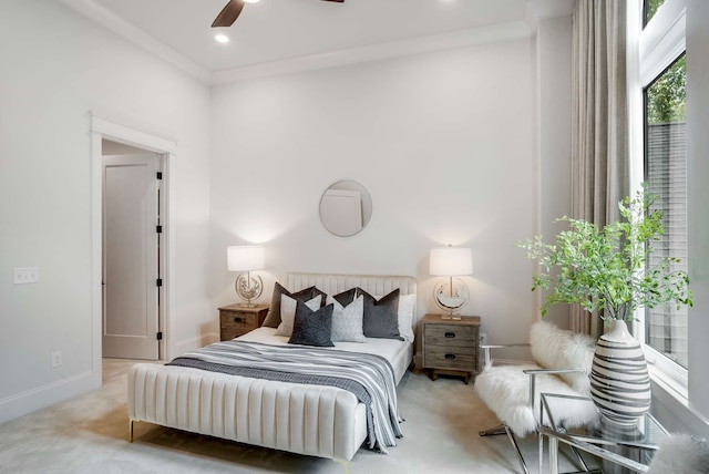 bedroom featuring light carpet, ceiling fan, and crown molding