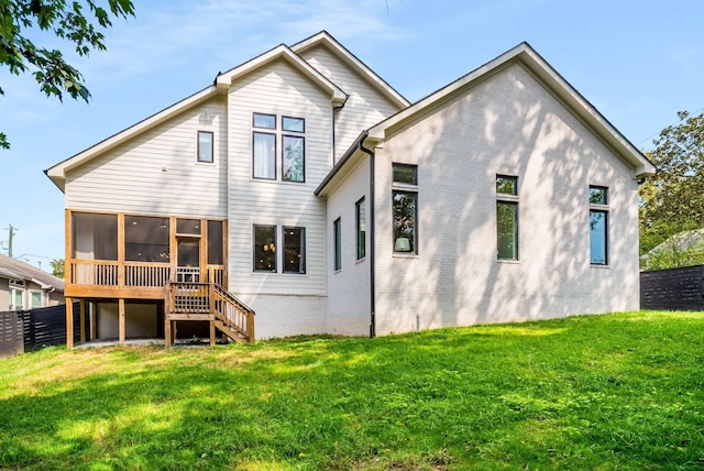 back of property with a sunroom and a yard