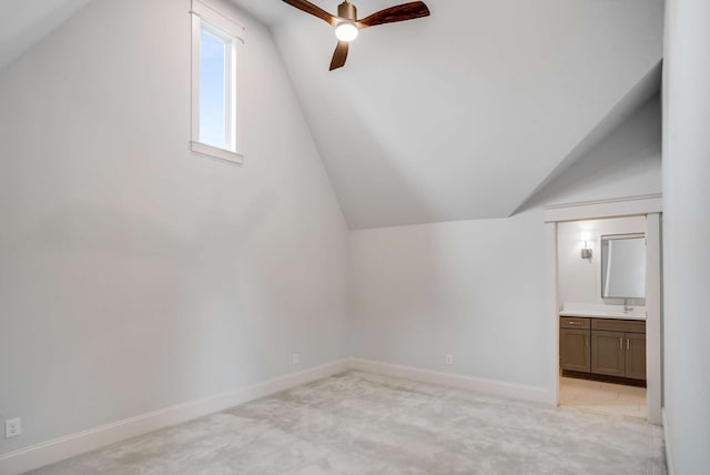 bonus room with light carpet, lofted ceiling, sink, and ceiling fan