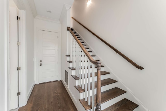 stairs with crown molding and hardwood / wood-style floors