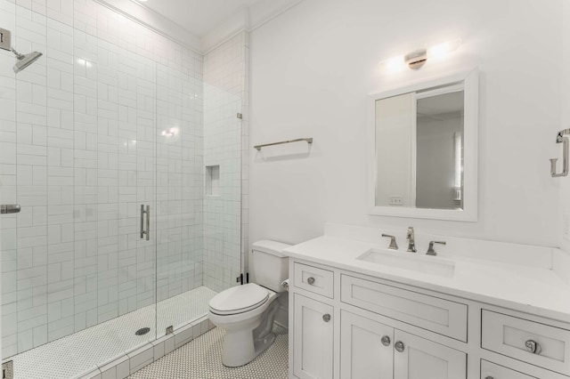 bathroom featuring vanity, a shower with shower door, toilet, and tile patterned flooring