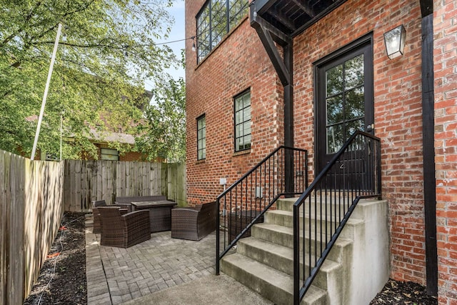 doorway to property featuring an outdoor living space and a patio area