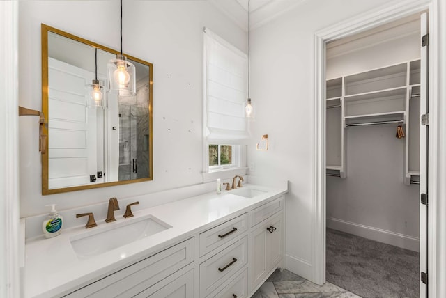 bathroom with ornamental molding, a shower with shower door, and vanity