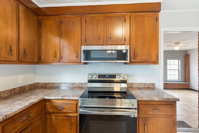 kitchen with appliances with stainless steel finishes, backsplash, a textured ceiling, and ceiling fan