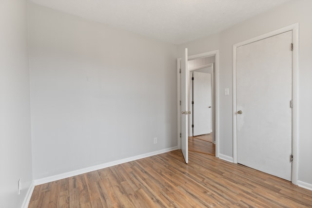 unfurnished bedroom featuring a textured ceiling and light wood-type flooring