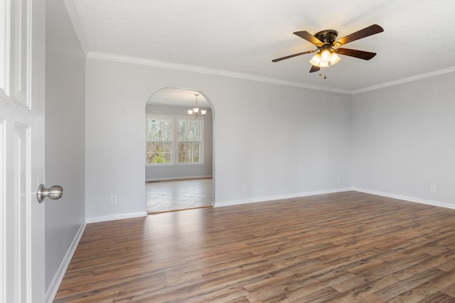 empty room with ceiling fan with notable chandelier, wood-type flooring, and ornamental molding