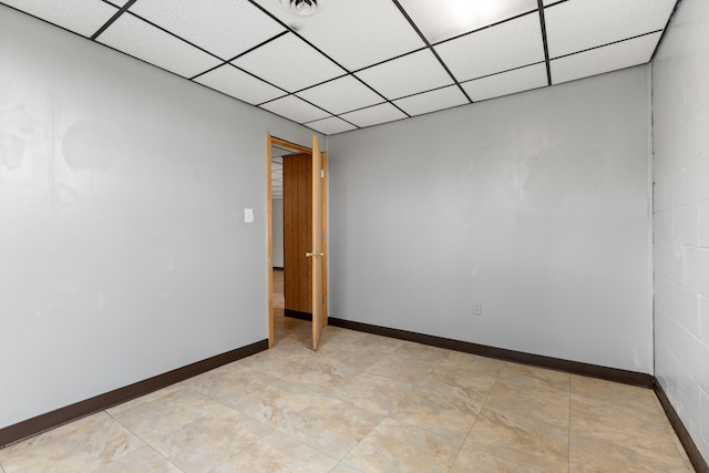 empty room featuring a drop ceiling