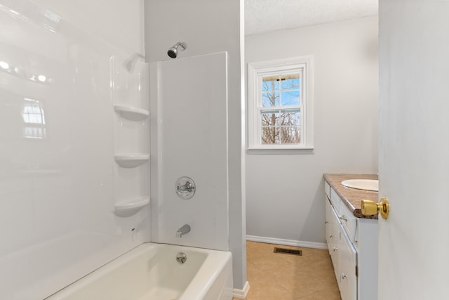 bathroom featuring a textured ceiling, shower / bathtub combination, tile patterned flooring, and vanity