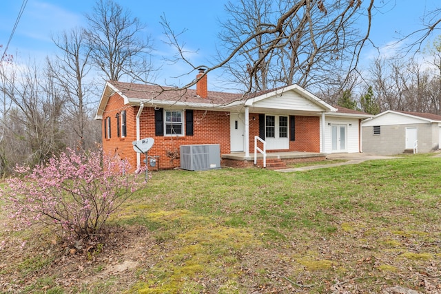 ranch-style home featuring a front yard and central AC unit