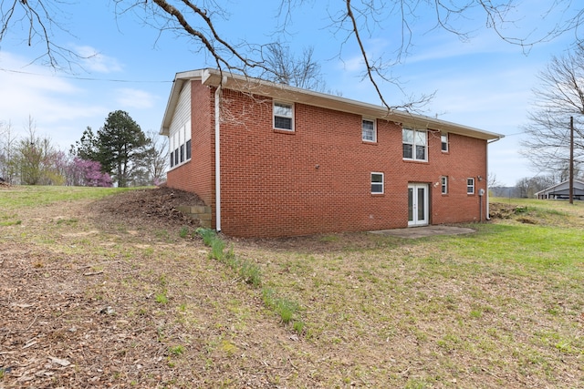 rear view of property featuring a yard