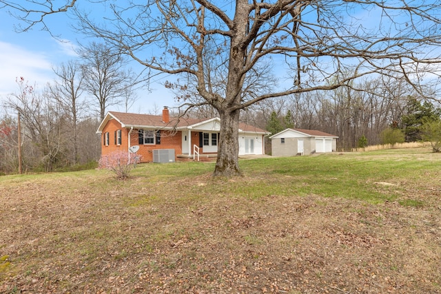 ranch-style house with central AC and a front lawn