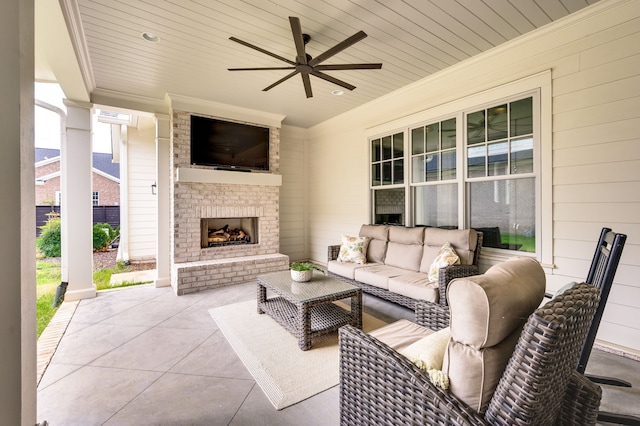 view of patio featuring ceiling fan and an outdoor living space with a fireplace