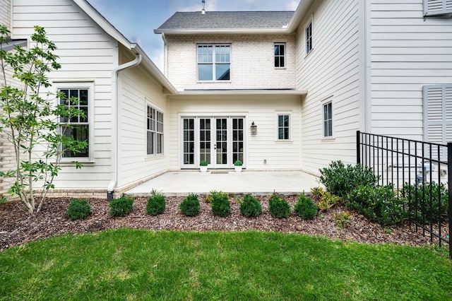 back of house with a yard and a patio area