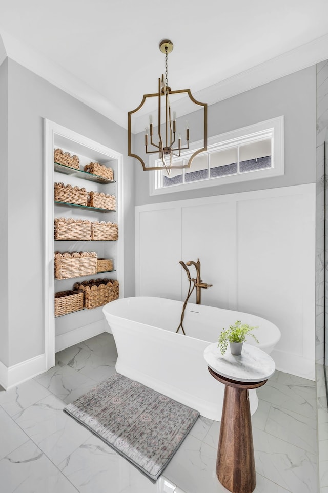 bathroom with a bath, crown molding, and an inviting chandelier