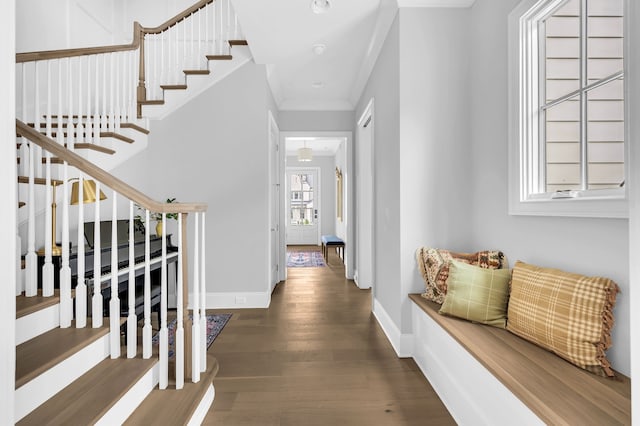 hallway featuring ornamental molding and dark hardwood / wood-style flooring