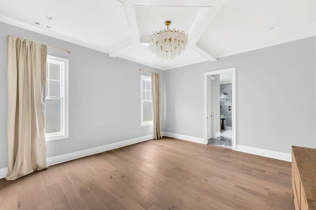 unfurnished room featuring light hardwood / wood-style flooring and a chandelier