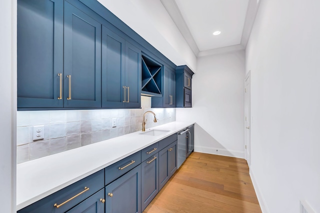 bar featuring blue cabinets, light hardwood / wood-style floors, sink, and stainless steel dishwasher