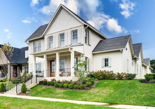 view of front of home with a front yard and a porch