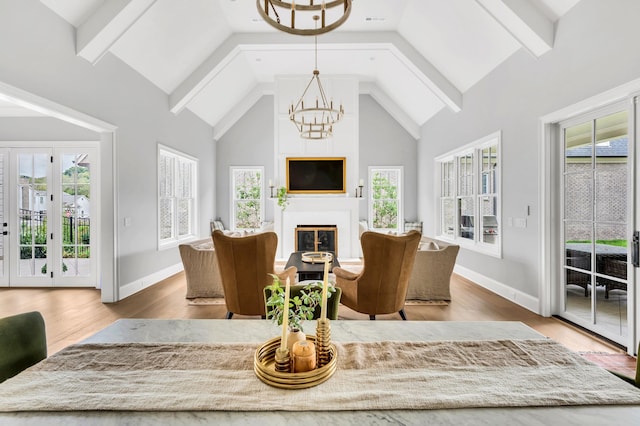 living room featuring a healthy amount of sunlight, hardwood / wood-style floors, and high vaulted ceiling