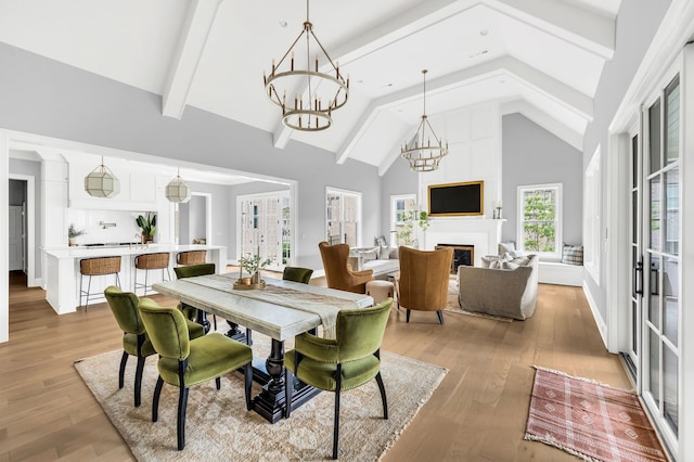 dining room featuring beamed ceiling, light hardwood / wood-style flooring, a notable chandelier, and high vaulted ceiling