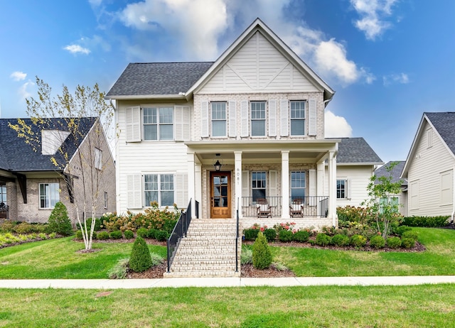 view of front of property with a front lawn and covered porch