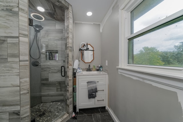 bathroom with ornamental molding, vanity, and an enclosed shower