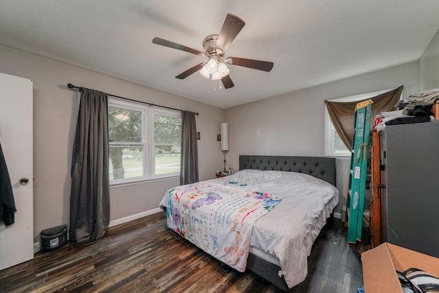 bedroom featuring ceiling fan, a textured ceiling, and dark hardwood / wood-style flooring