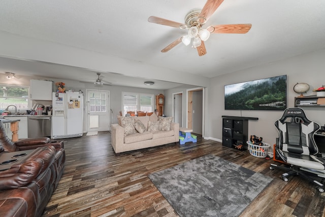 living room featuring hardwood / wood-style floors, ceiling fan, and a wealth of natural light