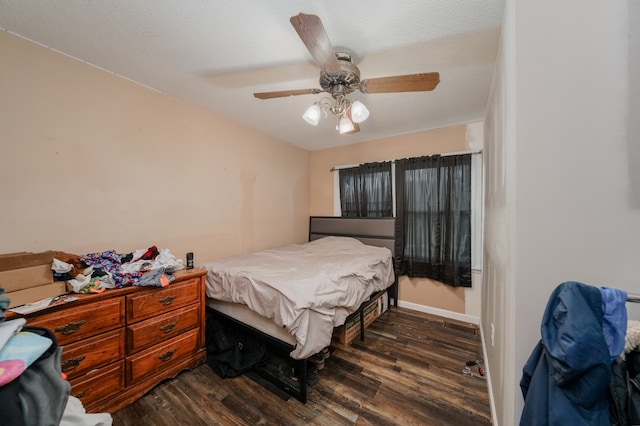 bedroom featuring a textured ceiling, ceiling fan, and dark hardwood / wood-style flooring