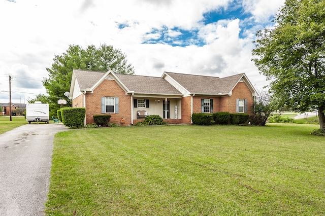 ranch-style home featuring a front yard