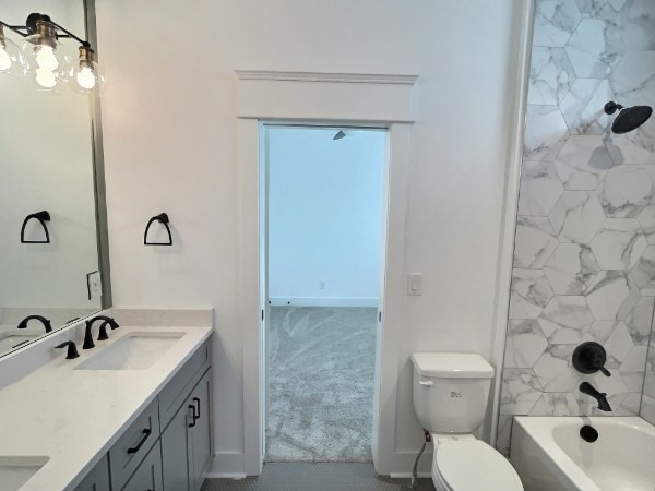 full bathroom with an inviting chandelier, tiled shower / bath, vanity, and toilet