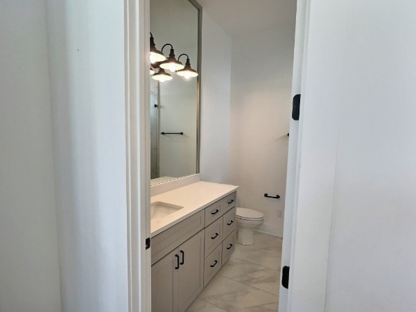 bathroom featuring vanity and toilet