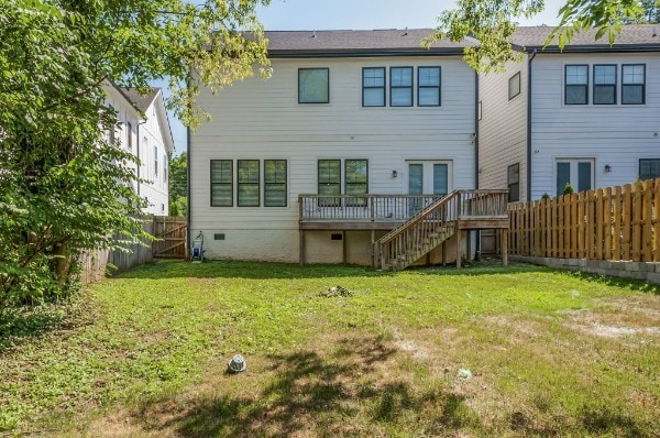 rear view of house featuring a yard