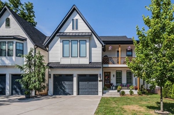 view of front facade featuring a balcony, a garage, and a front lawn