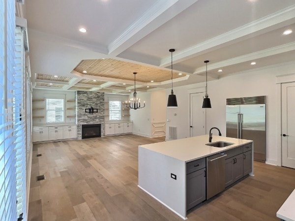 kitchen featuring sink, hanging light fixtures, gray cabinetry, light hardwood / wood-style flooring, and appliances with stainless steel finishes