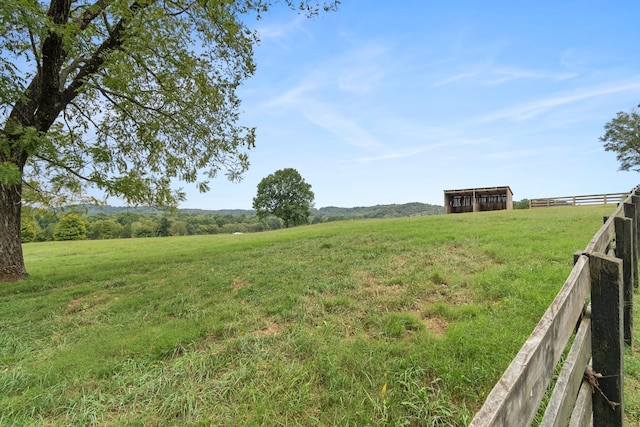 view of yard with a rural view